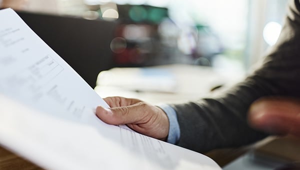 Business person holding contract.