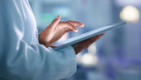 Business person touching tablet.