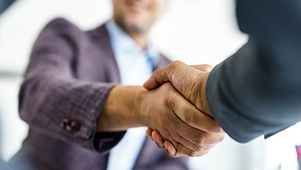 Two business people shaking hands.